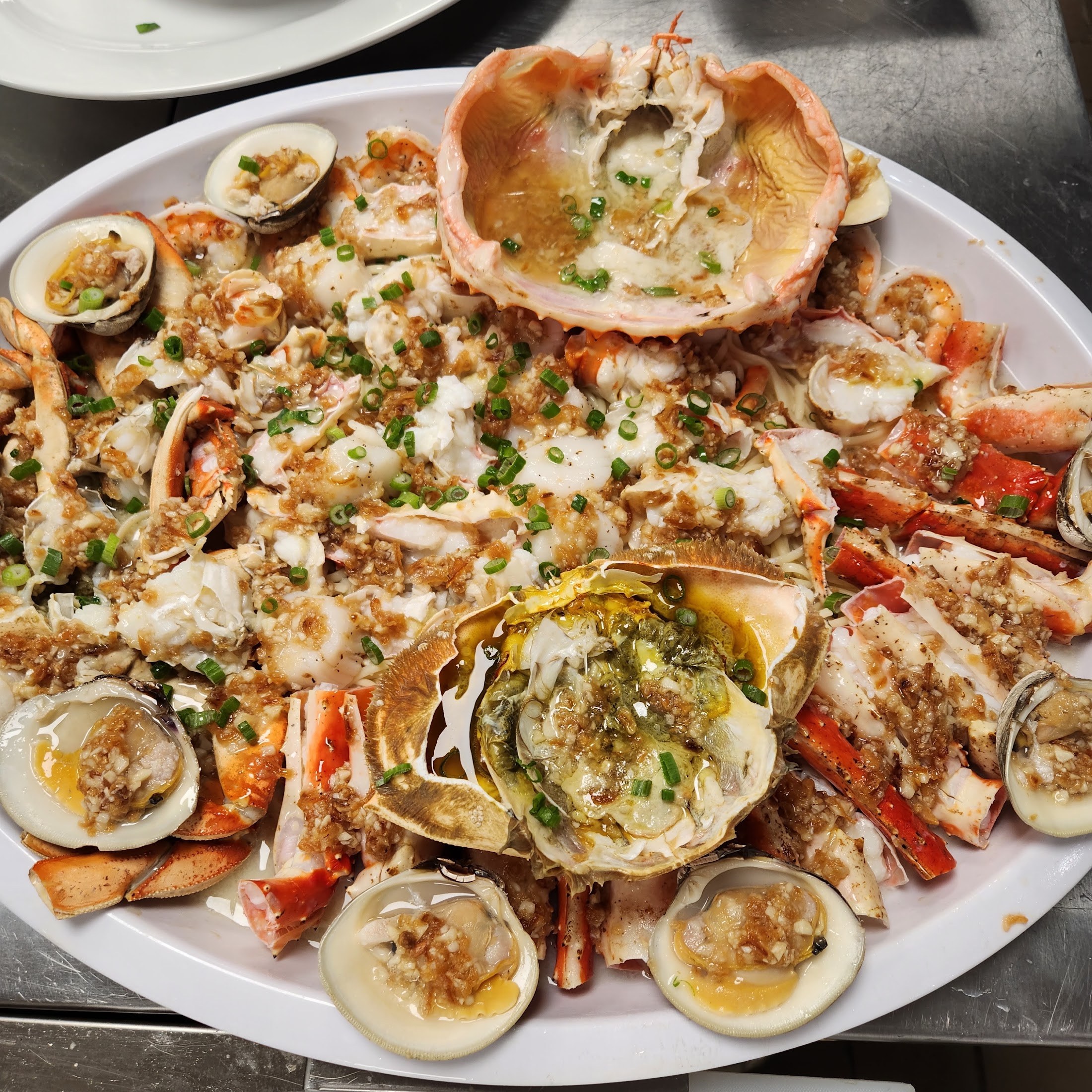 Dock3366 seafood platter with crab, shellfish, and garlic sauce